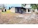 View of the home's large backyard, including a screened in porch, storage shed, and wooden privacy fence at 722 Eagle Ave, Longwood, FL 32750