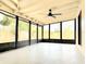 This is an airy, screened-in porch with light walls and a ceiling fan at 722 Eagle Ave, Longwood, FL 32750