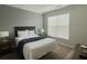 Neutral colored bedroom featuring natural lighting, with a queen size bed and matching end tables at 8010 Tuscany Way # 5206, Davenport, FL 33896