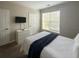 Inviting bedroom showcasing a window providing natural light and a flatscreen television on the adjacent wall at 8010 Tuscany Way # 5206, Davenport, FL 33896