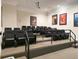 Community theater room with tiered seating, projector, and movie posters at 8010 Tuscany Way # 5206, Davenport, FL 33896