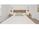 View of the primary bedroom and the wooden headboard with decorative lamps at 8903 Caroline Bay Ct, Kissimmee, FL 34747