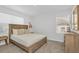 Bedroom featuring carpet, queen bed, side table, dresser, and dual windows at 8903 Caroline Bay Ct, Kissimmee, FL 34747