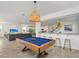 Open concept game room featuring pool table and bar area that opens to the kitchen and living room at 8903 Caroline Bay Ct, Kissimmee, FL 34747