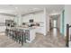 Eat-in kitchen featuring modern white cabinets, black and white patterned island, and tile flooring at 8903 Caroline Bay Ct, Kissimmee, FL 34747