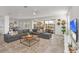 Bright living room featuring a comfortable sectional sofa and sliding glass doors to the lanai at 8903 Caroline Bay Ct, Kissimmee, FL 34747