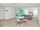 Upstairs living room showcasing a couch, accent wall, dining table, and mounted television at 8903 Caroline Bay Ct, Kissimmee, FL 34747