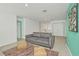 Upstairs living room featuring a gray couch, colorful rug and walk in closet at 8903 Caroline Bay Ct, Kissimmee, FL 34747