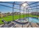 Soak up the sun on the lounge chairs next to the screened in pool and spa at 8903 Caroline Bay Ct, Kissimmee, FL 34747