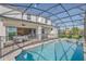 Picture of the private pool and spa, backyard, covered patio and home from within the screen enclosure at 8903 Caroline Bay Ct, Kissimmee, FL 34747