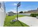 Backyard with a basketball court, a storage shed, and a lush green lawn at 905 Bella Vista Way, Orlando, FL 32825