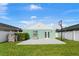 This backyard features a basketball hoop, lush green lawn, and a clean white exterior at 905 Bella Vista Way, Orlando, FL 32825