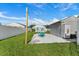 Backyard patio area with string lights, picnic table, shed, and grassy area offer a great place for outdoor activities at 905 Bella Vista Way, Orlando, FL 32825