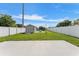 Backyard featuring a storage shed, a patio set, and a white fence at 905 Bella Vista Way, Orlando, FL 32825