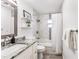 Bright bathroom featuring a shower-tub combo, modern vanity, and stylish, neutral tiling at 905 Bella Vista Way, Orlando, FL 32825