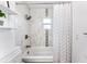 Bathroom showcasing a sleek, tiled shower-tub with elegant fixtures and bright natural light at 905 Bella Vista Way, Orlando, FL 32825