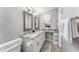 Bathroom with double vanity, elegant mirrors and towel storage for convenience at 905 Bella Vista Way, Orlando, FL 32825