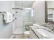 Bathroom featuring a tiled shower with glass doors, and a marble-topped vanity at 905 Bella Vista Way, Orlando, FL 32825