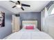 Bedroom showcases a ceiling fan, bright windows with blinds, and simple decor at 905 Bella Vista Way, Orlando, FL 32825