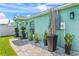 Exterior of home featuring landscaped yard and multiple potted snake plants along walkway at 905 Bella Vista Way, Orlando, FL 32825