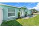 Charming home featuring a white front door with decorative plants and a well-manicured lawn at 905 Bella Vista Way, Orlando, FL 32825