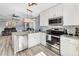 Bright kitchen with stainless steel appliances, granite countertops, and white cabinetry at 905 Bella Vista Way, Orlando, FL 32825