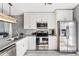 Bright kitchen with stainless steel appliances, granite countertops, and white cabinetry at 905 Bella Vista Way, Orlando, FL 32825