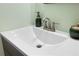 Close-up of a clean white bathroom sink with elegant fixtures and a decorative soap dispenser at 910 Florida Blvd, Altamonte Springs, FL 32701