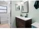 Bright bathroom with a dark vanity, white walls, and a combined tub and shower at 910 Florida Blvd, Altamonte Springs, FL 32701