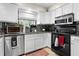 Kitchen featuring stainless steel appliances, white cabinets, and a window providing natural light at 910 Florida Blvd, Altamonte Springs, FL 32701