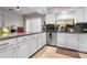 Bright kitchen featuring white cabinetry, granite countertops, and a mosaic tile backsplash at 910 Florida Blvd, Altamonte Springs, FL 32701