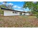 Home's backyard featuring a white house, grass, and trees at 921 W Lake Brantley Rd, Altamonte Springs, FL 32714