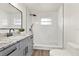 Updated bathroom featuring marble tile shower, modern vanity with granite countertop, and black hardware at 921 W Lake Brantley Rd, Altamonte Springs, FL 32714