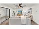 Stylish living room featuring wood flooring, contemporary decor, a ceiling fan, and a brick accent wall at 921 W Lake Brantley Rd, Altamonte Springs, FL 32714