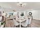 Bright living room with a white brick wall, modern decor, wood flooring, and a dining area at 921 W Lake Brantley Rd, Altamonte Springs, FL 32714