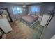 This bedroom features wood-look floors, neutral paint, a ceiling fan, and natural light at 1002 Royalton Rd, Orlando, FL 32825