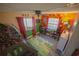 This bedroom features red and green walls, wood-look floors, and natural light at 1002 Royalton Rd, Orlando, FL 32825