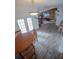 Open dining room with wood-look floors, a rustic wood wall, and a modern light fixture at 1002 Royalton Rd, Orlando, FL 32825