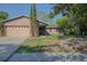 Charming single-story home features a well-maintained lawn, two-car garage and mature landscaping at 1002 Royalton Rd, Orlando, FL 32825