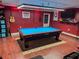 A home game room boasts a pool table, guitars, and a TV for entertainment at 1002 Royalton Rd, Orlando, FL 32825