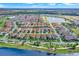 A panoramic aerial view of an upscale residential area featuring beautiful homes near a sparkling lake at 10249 Beechwood Ln, Orlando, FL 32832