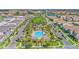 Aerial view of community pool surrounded by lush landscaping, palm trees, and well-maintained residential streets at 10249 Beechwood Ln, Orlando, FL 32832