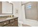 Bathroom features granite counters, undermount sink, and tiled shower with window at 10249 Beechwood Ln, Orlando, FL 32832