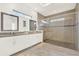 Modern bathroom featuring granite countertops, dual sinks, and a glass-enclosed shower at 10249 Beechwood Ln, Orlando, FL 32832