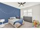 Bedroom with carpet, accent wall, and window with blinds at 10249 Beechwood Ln, Orlando, FL 32832