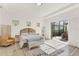 Serene main bedroom with patio access, light wood floors, and neutral decor at 10249 Beechwood Ln, Orlando, FL 32832