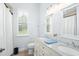 Bright bathroom with double vanity, granite countertop, framed mirrors, and plantation shutters at 10361 Mallard Landings Way, Orlando, FL 32832