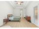 Comfortable bedroom featuring a ceiling fan, tray ceiling, and sliding glass doors at 10361 Mallard Landings Way, Orlando, FL 32832