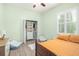 Bedroom featuring wood floors, closet with built-ins, plantation shutters, and a ceiling fan at 10361 Mallard Landings Way, Orlando, FL 32832