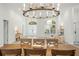 Elegant dining space with a wooden table, stylish chandelier, and views of the entry way and sitting area at 10361 Mallard Landings Way, Orlando, FL 32832